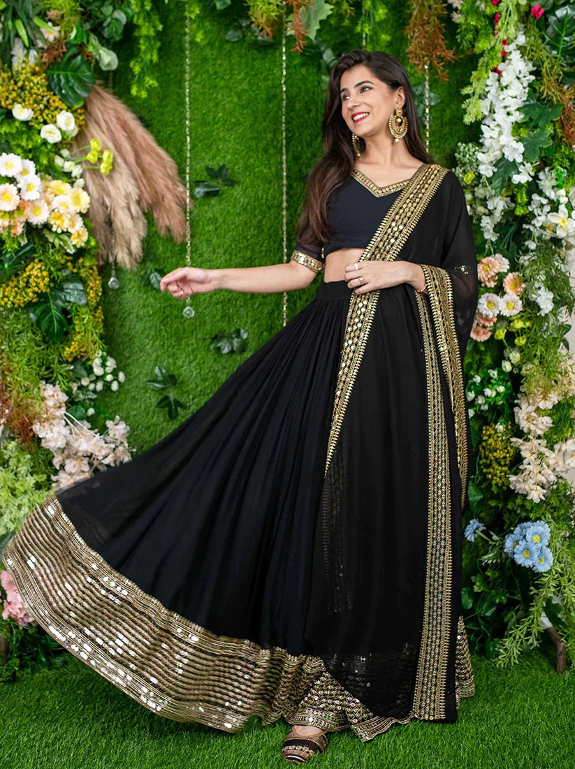 Black Georgette Mirror Work Lehenga Choli with Gold Trim, styled on model, view 2